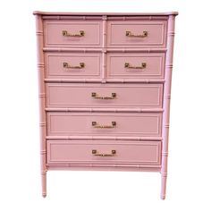 a pink dresser with gold handles and drawers on the bottom drawer, against a white background