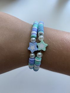 This bracelet is a cute summer friendship bracelet with blue and turquoise stars Blue Handmade Star-shaped Beaded Bracelets, Handmade Blue Star-shaped Bracelet, Handmade Blue Star Bracelet, Blue Beaded Star-shaped Bracelets, Blue Beaded Bracelets With Star Charm, Playful Adjustable Blue Friendship Bracelets, Blue Bracelets With Star Charm For Gift, Blue Bracelet With Star Charm As Gift, Trendy Turquoise Friendship Bracelets With Letter Beads