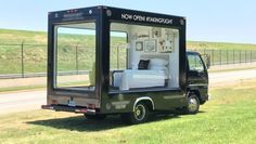 a truck with a bed in the back is parked on the side of the road