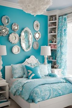 a bedroom decorated in blue and white with lots of mirrors on the wall above the bed