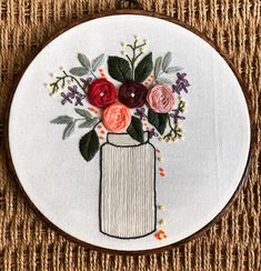 a white embroidery hoop with some flowers in it