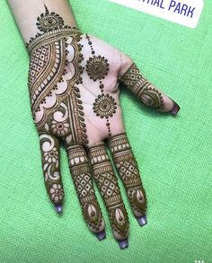 the hand is decorated with henna and flowers on it's palm, which reads central park