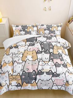 a bed covered in lots of cats on top of a wooden floor next to a white wall