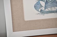 a watercolor painting of a sailboat in blue and white on burlap