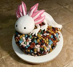 a cake that looks like a white dragon with pink wings on it's head