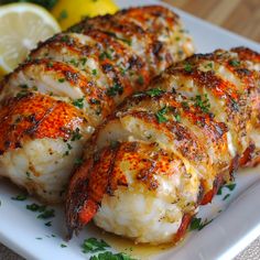 grilled shrimp on a plate with lemon wedges and parsley garnish