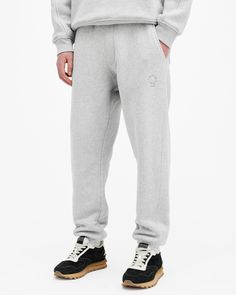 An update you've been waiting for. These are the Haven Sweatpants. Made from heavyweight organic cotton to a relaxed fit. This classic shape features tonal embroidery on the top of the leg – it's our signature, of course. For comfort, we've added a elasticated waistband and cuffs that are offset with sophisticated finishings including twin needle stitch detailing and curved seams.  These sweatpants are designed to a relaxed fit Pull-on Drawcord waist Elasticated waistband and cuffs Fake fly stit All Saints Logo, Embroidered Sweatpants, Fly Stitch, Sweatpants Grey, Tonal Embroidery, Mens Activewear, All Saints, Gray Color, Active Wear