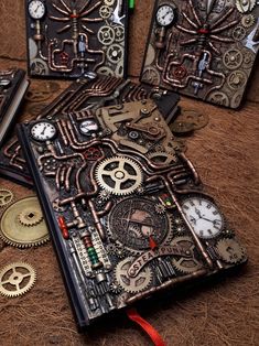 four notebooks with gears on them are sitting on the ground next to each other