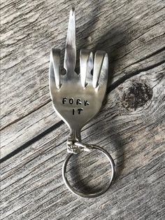 a metal fork with the word fork it on it