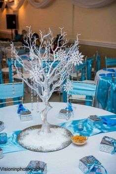 a white table topped with blue and silver decorations