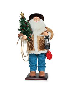 a christmas ornament with a santa holding a small tree and a lamppost