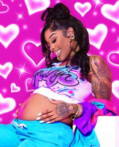 a woman with tattoos on her stomach and belly sitting in front of pink heart backdrop