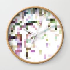 a wall clock with many different colored squares on the front and back of it's face