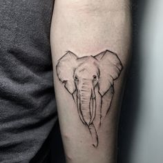 an elephant head tattoo on the arm