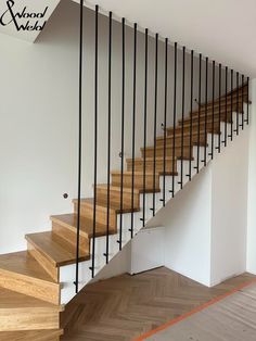 an empty room with wooden stairs and white walls