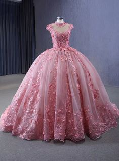 Bask in the elegance of this stunning pink ball gown, a perfect choice for a romantic and unforgettable wedding. The high neckline, beautifully adorned with lace and floral appliques, exudes sophistication and grace, while the cap sleeves add a sweet and delicate touch. The bodice is intricately detailed with lace that seamlessly transitions into the full, tulle skirt. The skirt is decorated with three-dimensional floral appliques that cascade down, creating a stunning and dynamic effect. This gown is ideal for brides who want to feel like a princess on their special day, making it perfect for fairy-tale weddings and grand celebrations. Enhance your look with simple, yet elegant jewelry and an updo to highlight the gown's intricate details. This dress is designed to make you feel like the Ballgown Aesthetic, White Lace Long Sleeve Wedding Dress, Pink Ball Gown, White Ball Gowns, White Lace Wedding Dress, Fairy Tale Wedding Dress, Wedding Clothing, Long Sleeve Wedding Dress Lace, Princess Ball Gowns