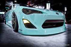 the front end of a light blue sports car