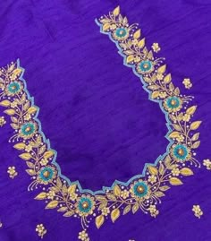 an embroidered purple cloth with gold and blue flowers on the border, along with beads