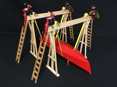 three wooden ladders are attached to a red boat