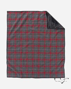 a red and grey plaid blanket on a white background