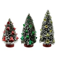 three small christmas trees with bows and bells on them, all decorated in different colors