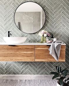 a bathroom sink with a mirror above it and a towel on the counter next to it