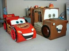 two cardboard cars are sitting on the floor