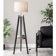 a lamp that is sitting on top of a table next to a couch and chair