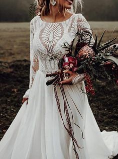 a woman in a white wedding dress holding a bouquet