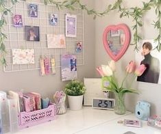 a white desk topped with lots of pictures and flowers