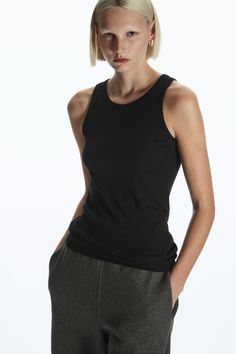 Made from organic cotton with a touch of stretch, this slim-fit tank top is an essential on warmer days. - Round neck- Sleeveless design- Organic cotton is grown from non-genetically modified seeds without chemical fertilisers or pesticides 97% Organic cotton, 3% Elastane / Machine washableBack length of size S is 61.5cm Classic Tank Top For Layering, Classic Ribbed Tank Top For Spring, Classic Solid Tank Top For Everyday, Classic Stretch Tank Top For Everyday, Classic Solid Color Tank Top For Everyday, Classic Everyday Stretch Tank Top, Classic Everyday Tank Top, Classic Seamless Everyday Tank Top, Classic Everyday Seamless Tank Top