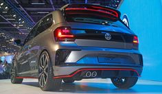 the rear end of a gray volkswagen car on display at an auto show in europe