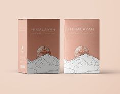 two boxes of himalayan tea on a pink background, one with a mountain scene and the other with a moon