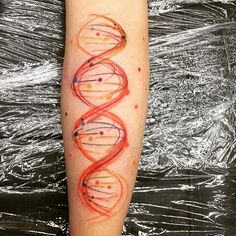 a person with a tattoo on their arm that has an image of two spirals