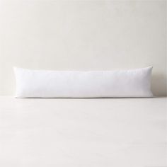 a white pillow sitting on top of a table