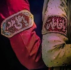 two people wearing colorful clothing with the word hello written on their armbands and holding each other's hand