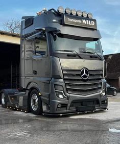 a large truck parked in front of a garage