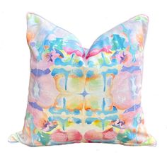 a colorful pillow with an abstract design on the front and back, sitting against a white background