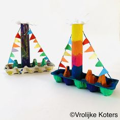 there are two boats made out of colored paper