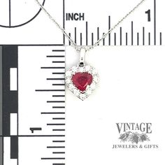 This stunning pendant features an .80 carat heart shaped natural ruby center stone, accompanied by 12 round brilliant natural diamonds totaling .25 carats. Set in a 14 karat white gold heart shaped diamond halo, this elegant piece also includes a 14 karat white gold, 18” length, 1 mm cable chain. .80 carat heart shaped natural ruby center stone 12 round brilliant, colorless, SI clarity, natural diamonds totaling .25 carats. 14 karat white gold hearts shaped diamond halo pendant. Includes 14 kara Gold Hearts, Halo Pendant, Heart Shaped Diamond, Natural Ruby, Diamond Halo, Gold Heart, Heart Of Gold, Halo Diamond, Cable Chain