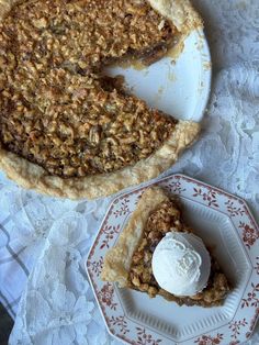 a piece of pie sitting on top of a white plate next to a slice of pie