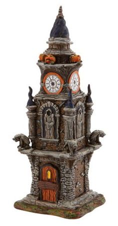 an ornate clock tower with two cats on it's sides and pumpkins around the top