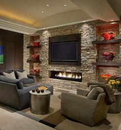 a living room filled with furniture and a flat screen tv mounted on the wall above a fire place