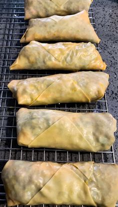 four pastries sitting on top of a metal rack