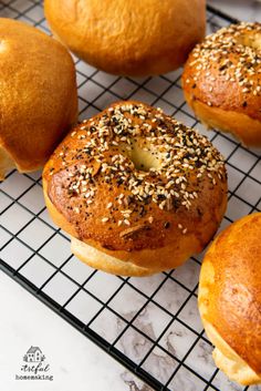 sesame seed bagels cooling on a wire rack