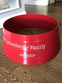 a large red bowl sitting on top of a wooden floor