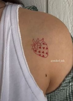 a woman with a strawberry tattoo on her shoulder