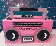 a pink boombox cake with the moon on it's side and name written on top