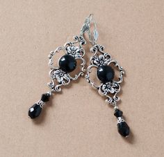 These elegant earrings are made from round black agate stone set in antique silver filigree setting, embellished with black waterdrop beads at the bottom. They will make a beautiful accessory for someone who loves Victorian or vintage style. -The earrings are 2.5 inches long, without the lever back closure and an inch wide at the widest part of the filigree setting -They have a lever back closure (lead and nickel free) SHIPPING: Default shipping is by regular mail, which does not have tracking, Black Dangling Earrings, Elegant Black Filigree Earrings, Black Filigree Dangle Jewelry, Elegant Black Oxidized Finish Earrings, Formal Black Filigree Earrings, Black Nickel-free Earrings For Wedding, Black Elegant Chandelier Earrings, Nickel Free, Nickel-free Black Earrings For Wedding, Nickel-free Black Wedding Earrings