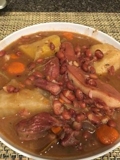 a white bowl filled with meat and beans